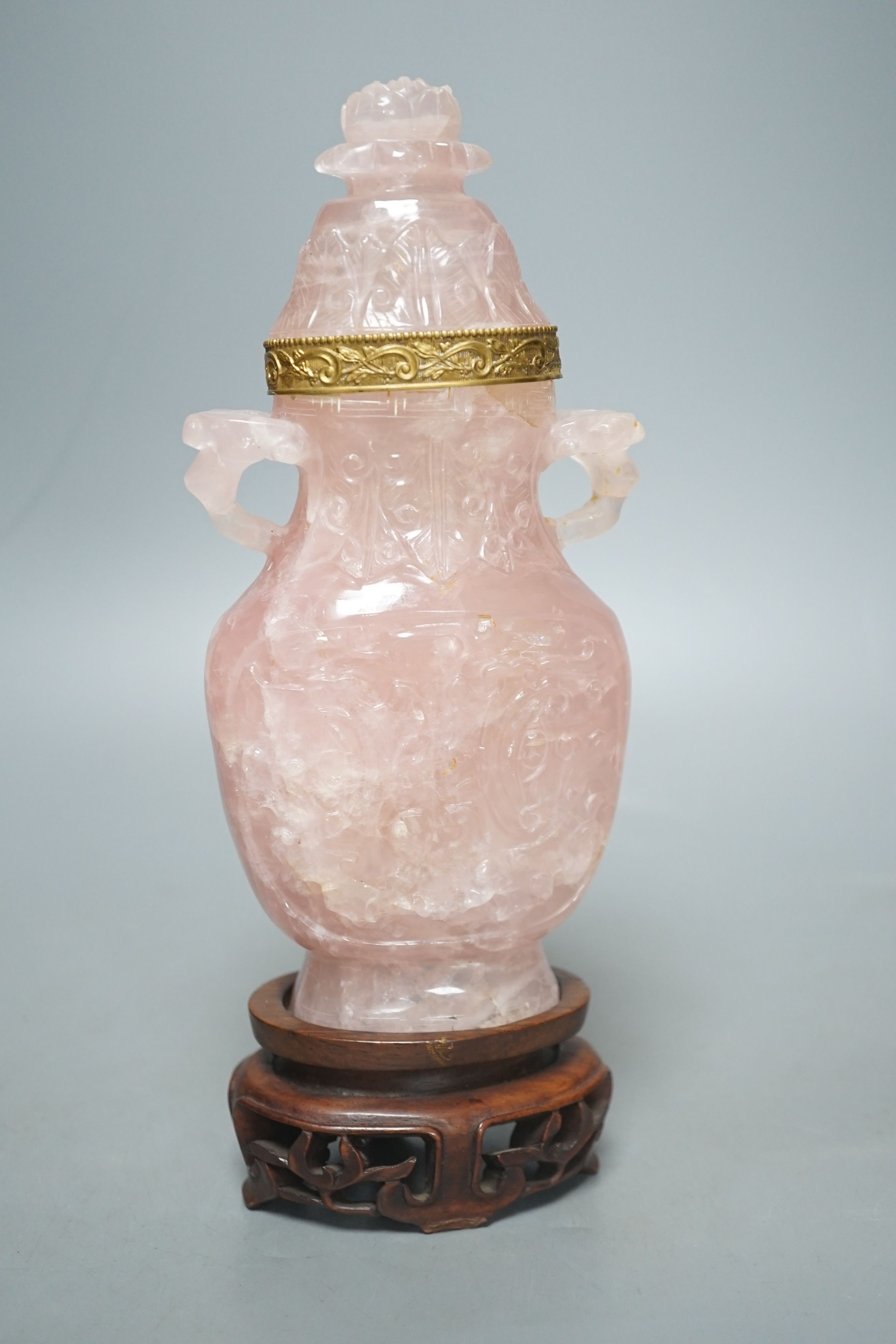 A late 19th/early 20th century Chinese carved rose quartz vase and cover, on a Hongmu stand, 23.5 cm high including stand.
